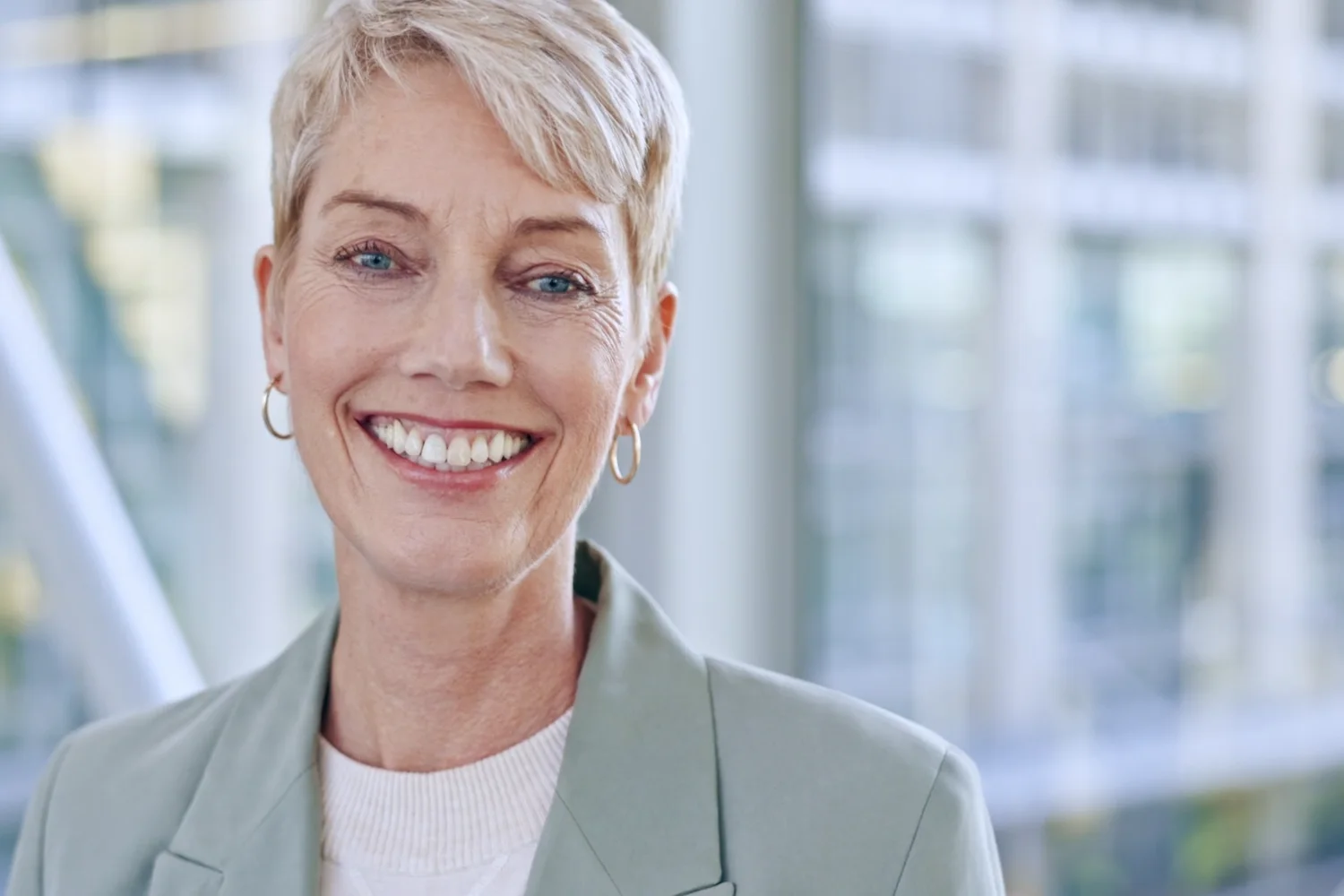 Smiling woman with short silver hair